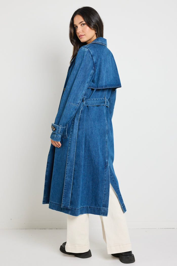 Model wears blue denim trench coat with tie waist and buttons
col_pattern