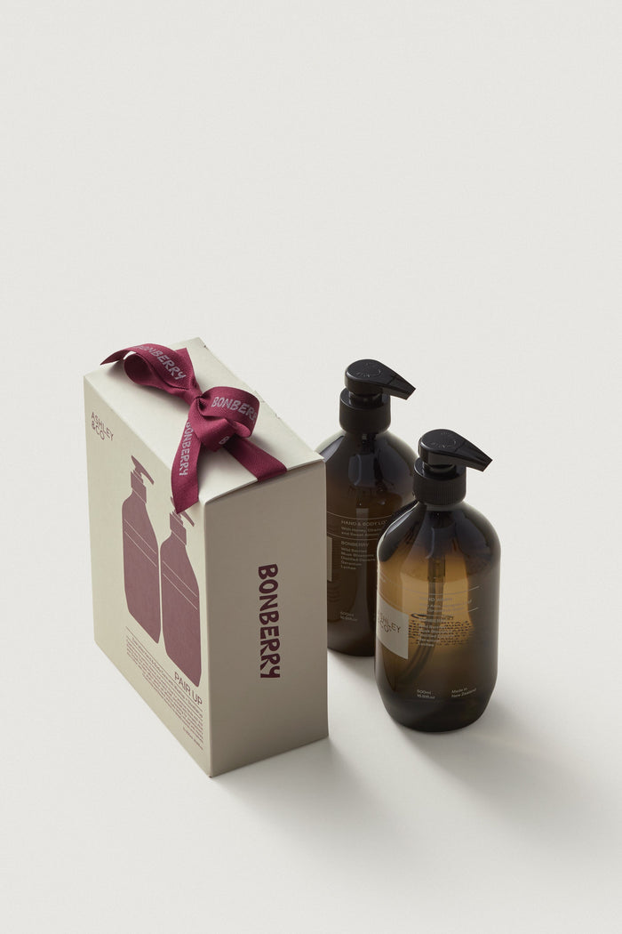 Two brown bottles with black pumps and a box labeled 'Bonberry' on a light gray background.