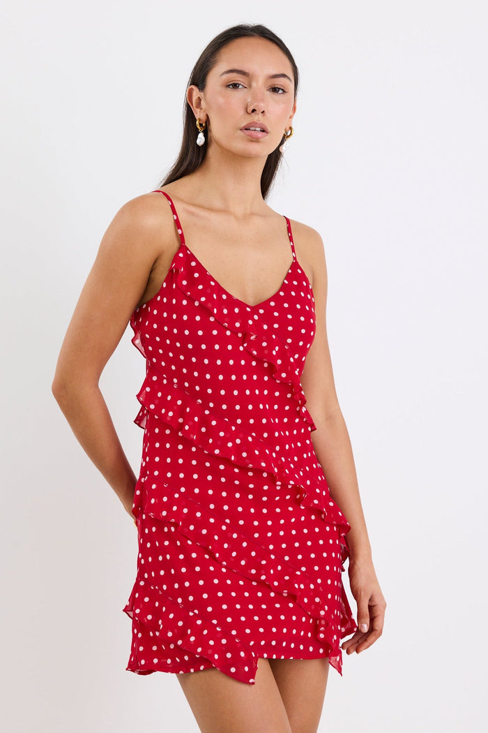 Woman wearing a mini red white polka dot ruffle dress