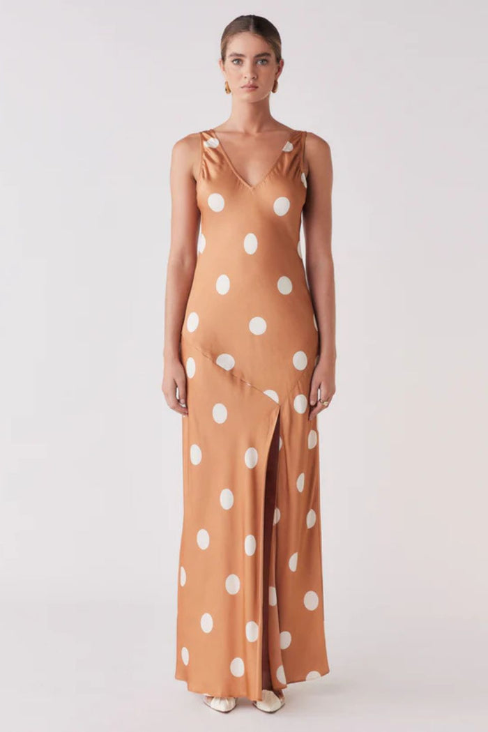 Woman wearing a brown and white spot dress