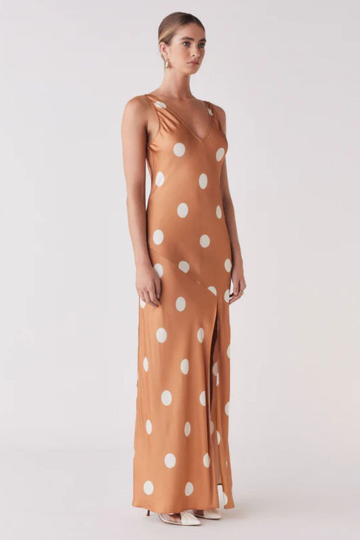 Woman wearing a brown and white spot dress