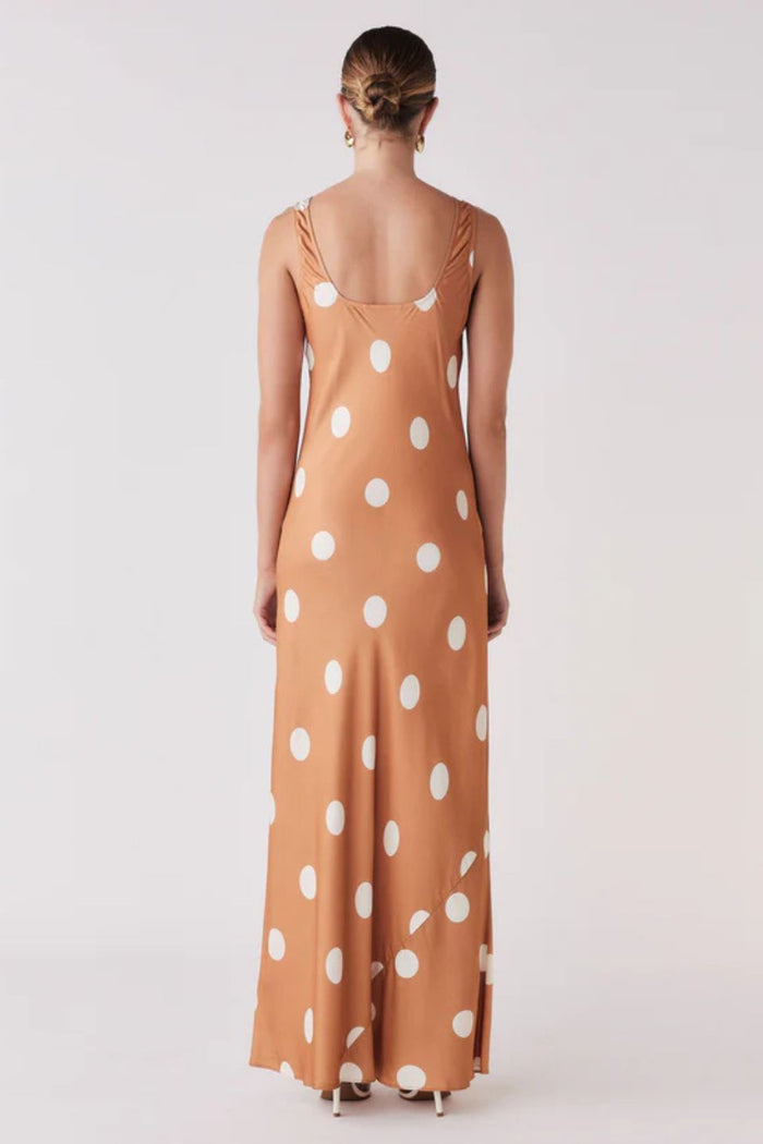 Woman wearing a brown and white spot dress