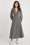 Woman wearing a black and white checkered dress on a white background