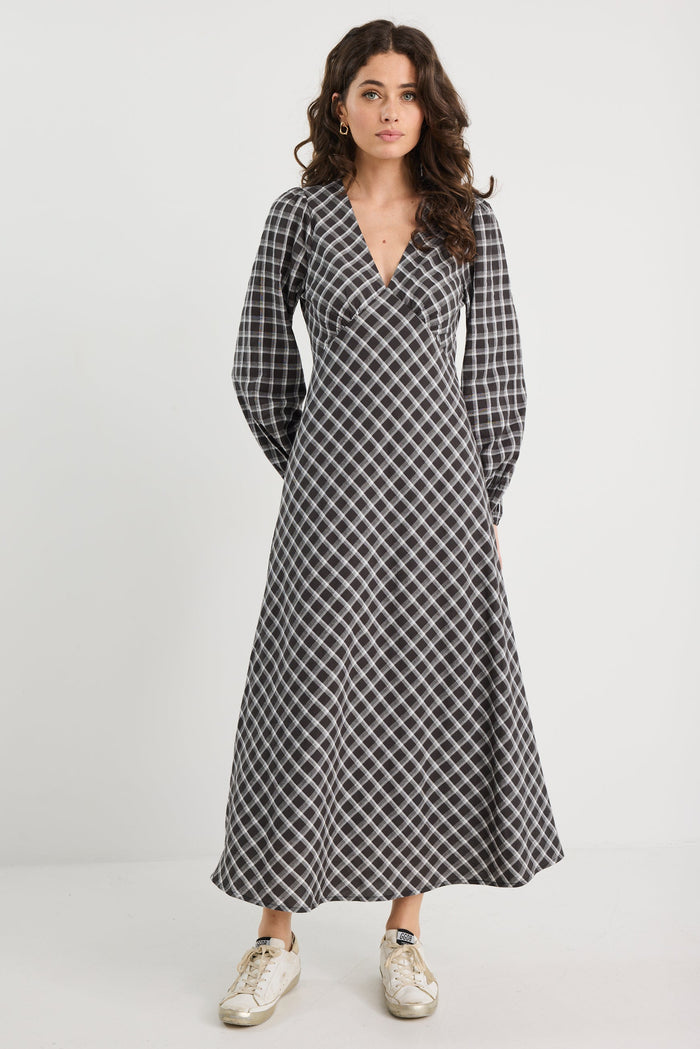 Woman wearing a black and white checkered dress on a white background