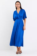 Woman wearing an electric blue satin jacquard midi dress with short kimono sleeves, a wrap-style bodice, and flowing skirt, standing against a white background