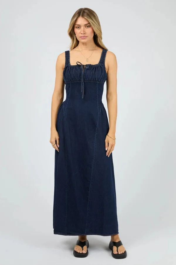 Woman wearing a navy blue dress on a white background