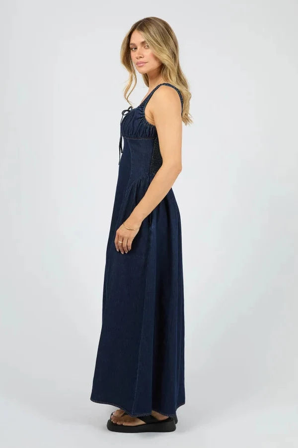 Woman wearing a navy blue dress on a white background