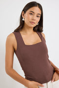 model wears a brown tank top with cream jeans