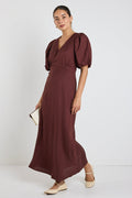 model wears a brown linen puff sleeve maxi dress