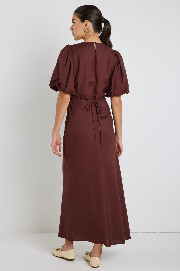 model wears a brown linen puff sleeve maxi dress