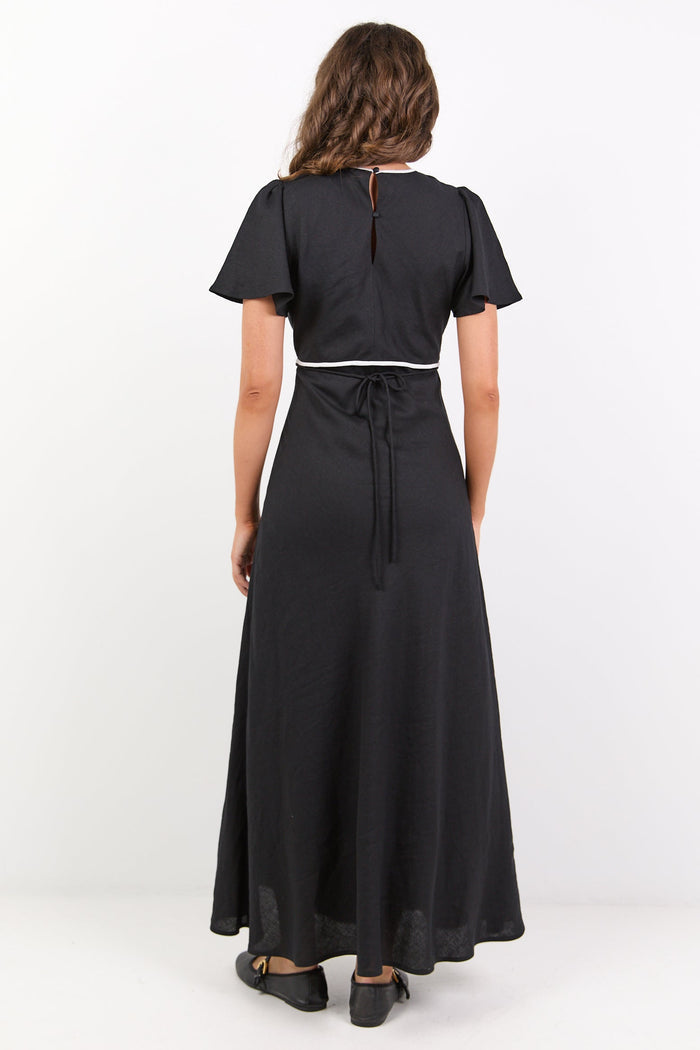 Woman wearing a black dress with a white background