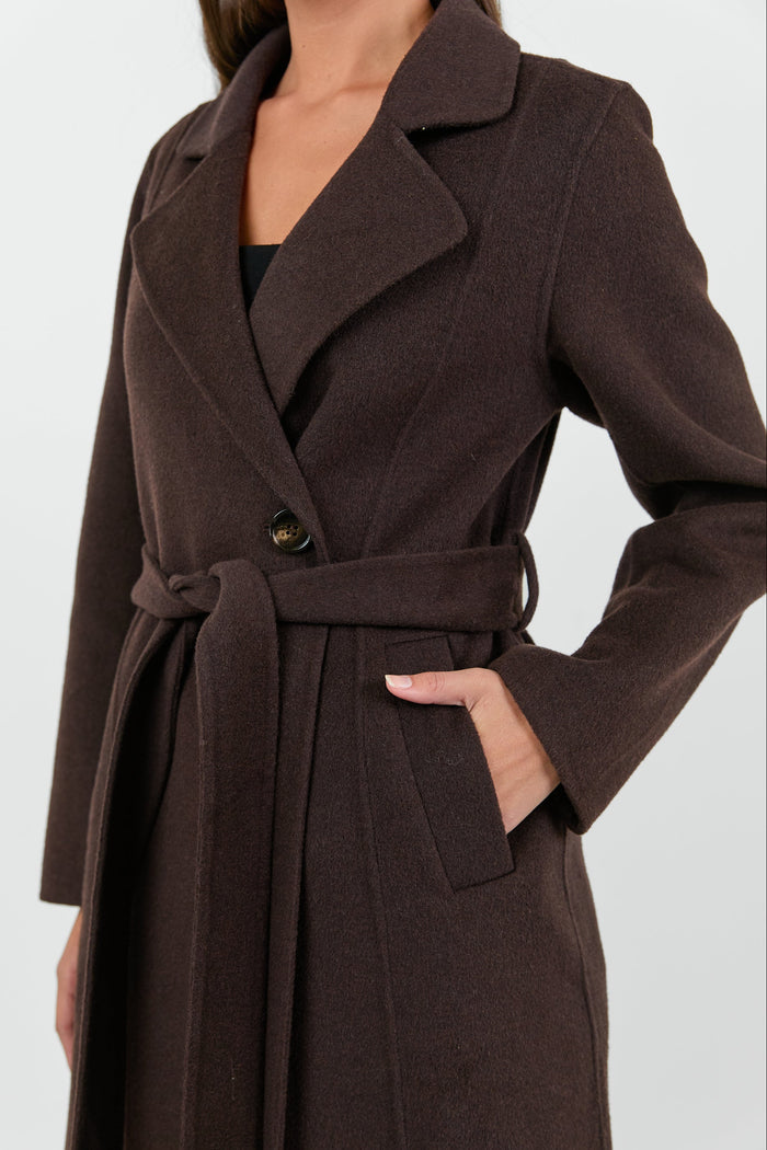 Brown coat worn by a person on a white background