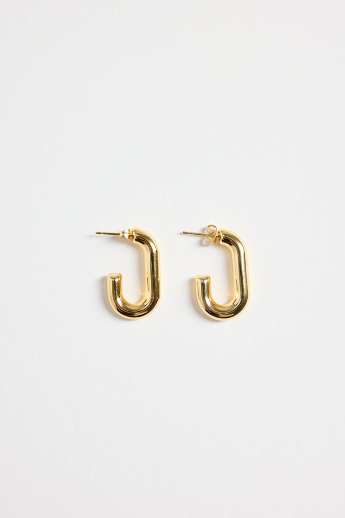 gold-plated brass huggie earrings with a sleek rectangular shape, photographed flat on a white background.