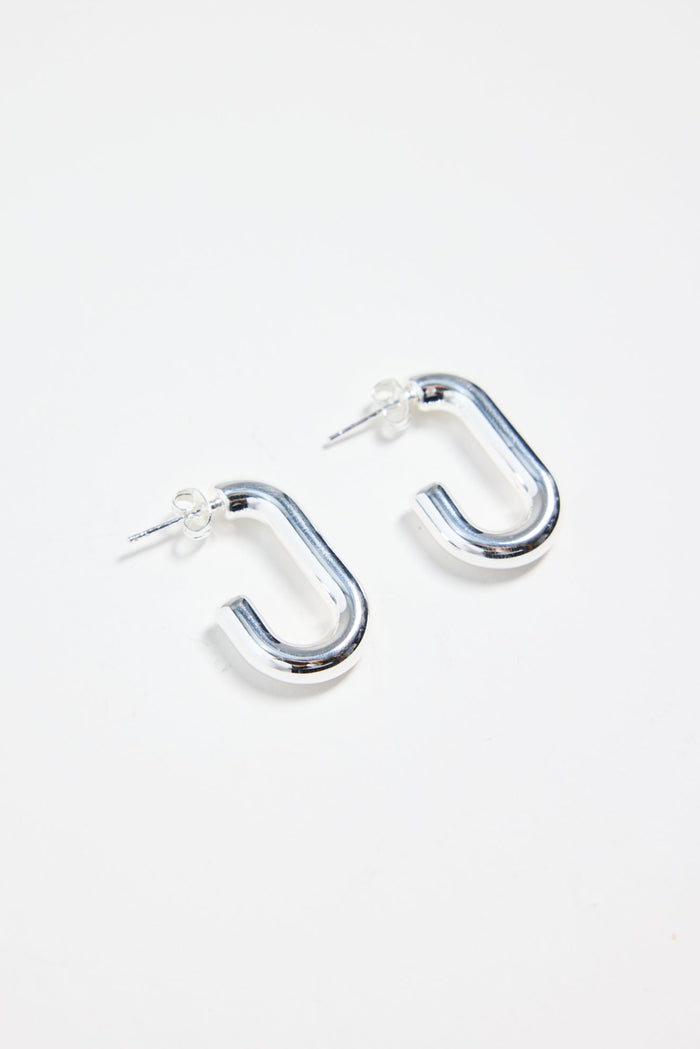 silver-plated brass huggie earrings with a rectangular shape, photographed flat on a white background.