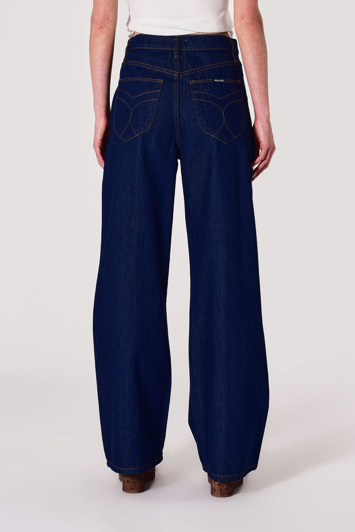 Person wearing wide-leg jeans on a white background
