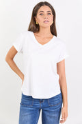 Woman wearing a white t-shirt and blue jeans on a white background