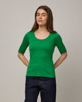Model wearing Celine Ribbed Elbow Sleeve Tee in Verde, a bright Kelly green color. Celine Ribbed Elbow Sleeve Tee is a merino wool short sleeve, scoop neck tee available in sizes XS-3X.