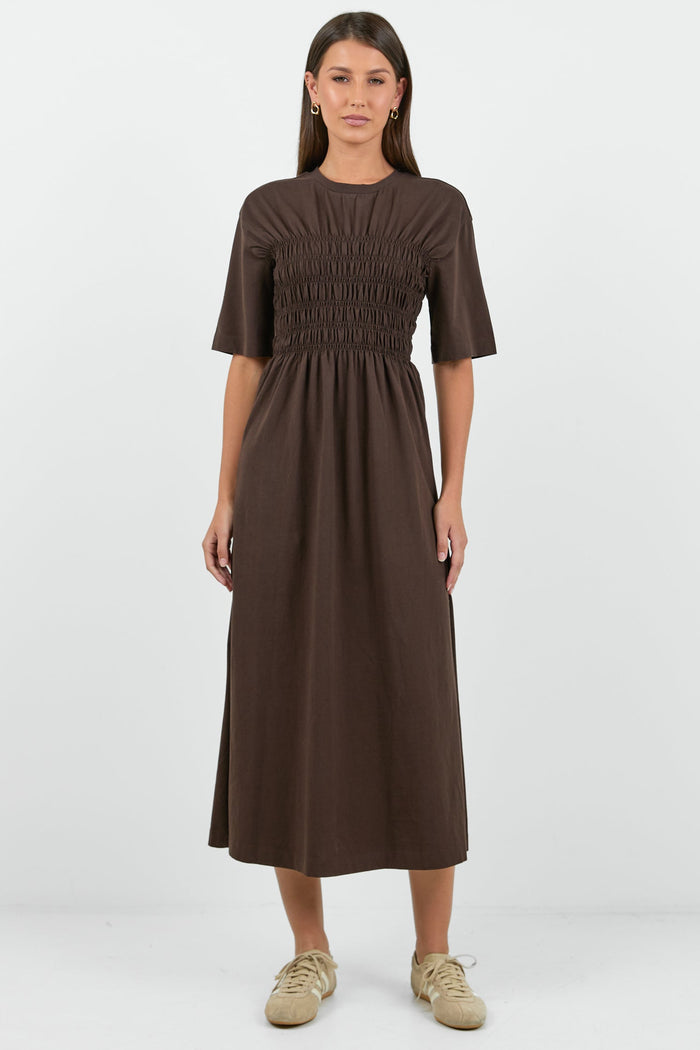 Woman wearing a brown dress on a white background