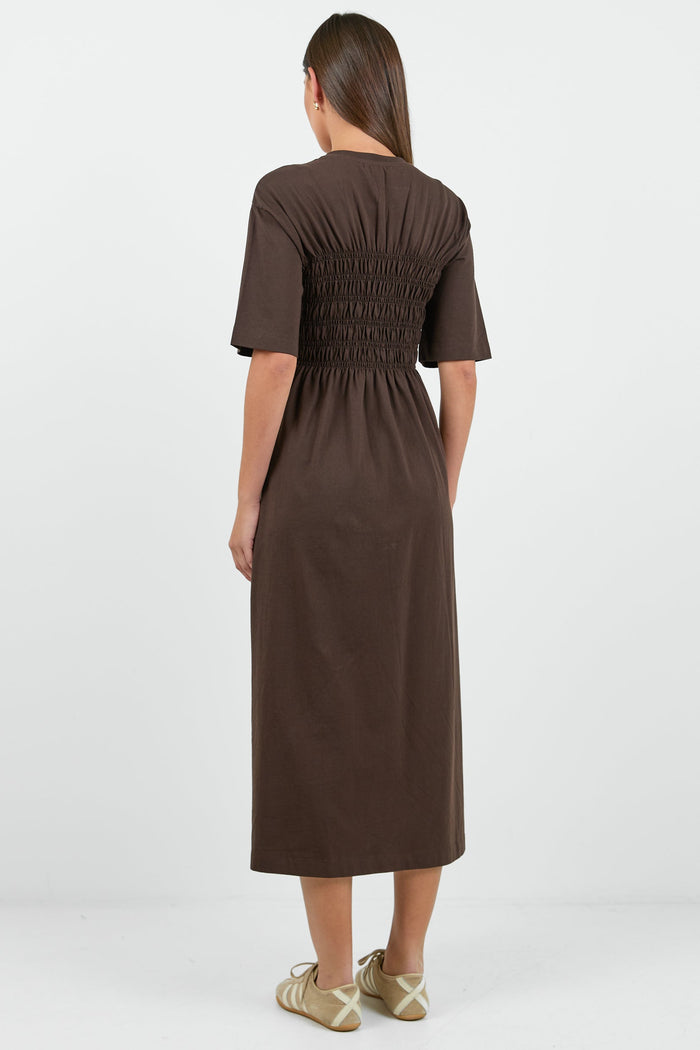Woman wearing a brown dress on a white background