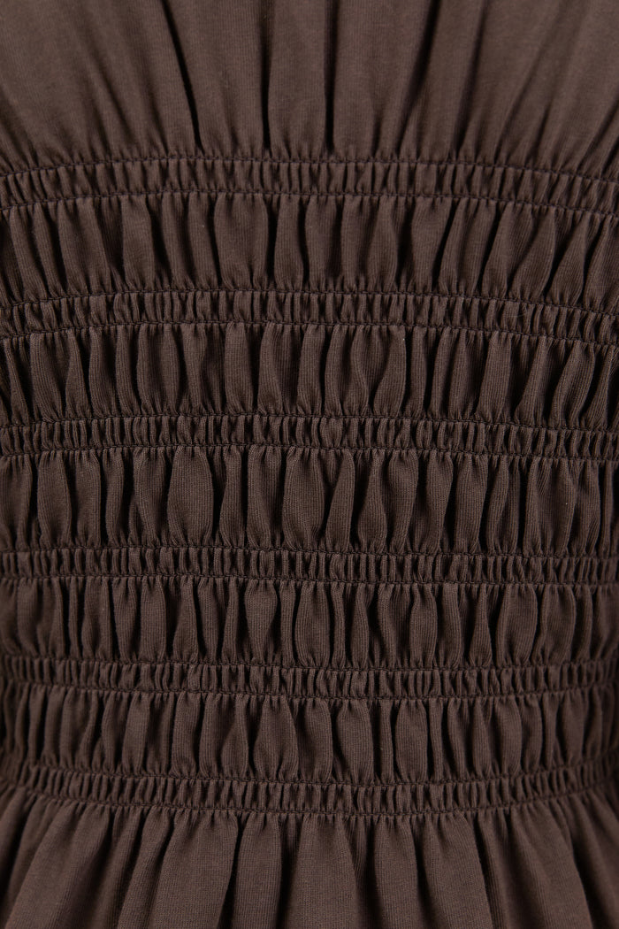 Close-up of brown fabric with gathered texture