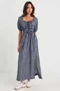 Woman wearing a blue checkered dress on a white background
