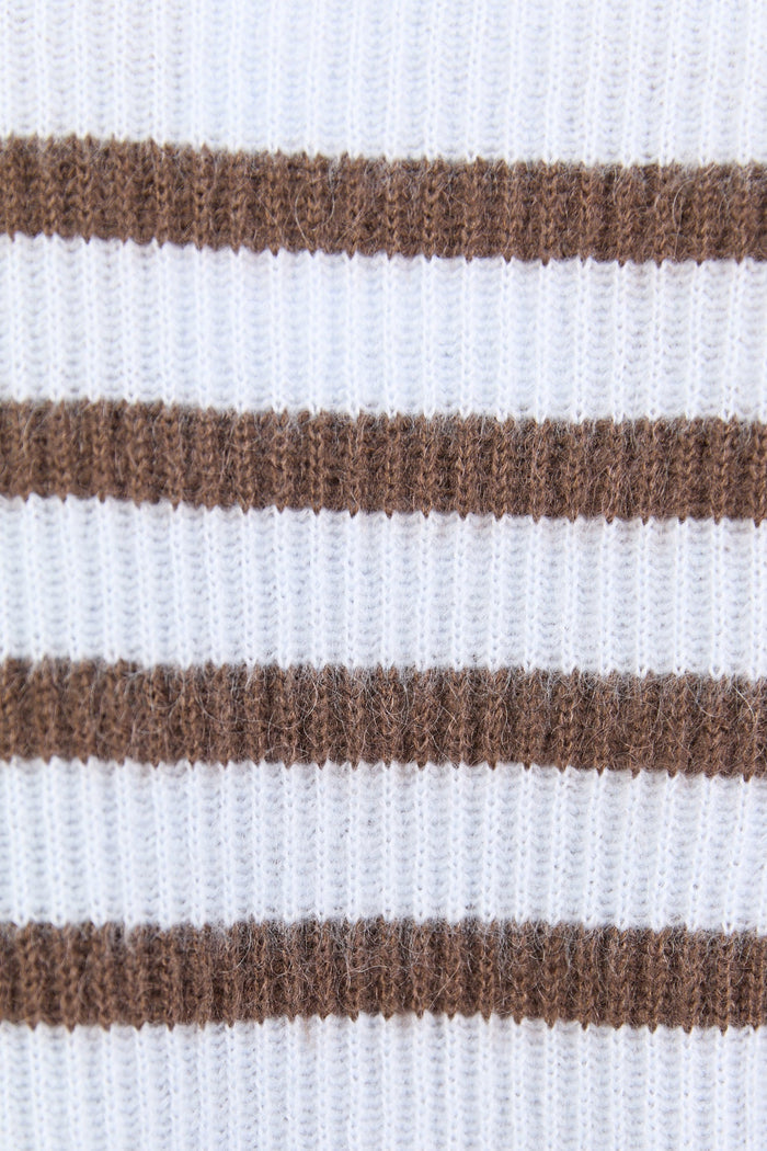 Close-up of a sweater with brown and white horizontal stripes.