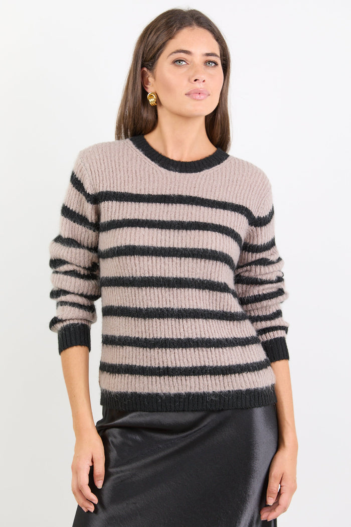 Woman wearing a striped sweater against a white background
