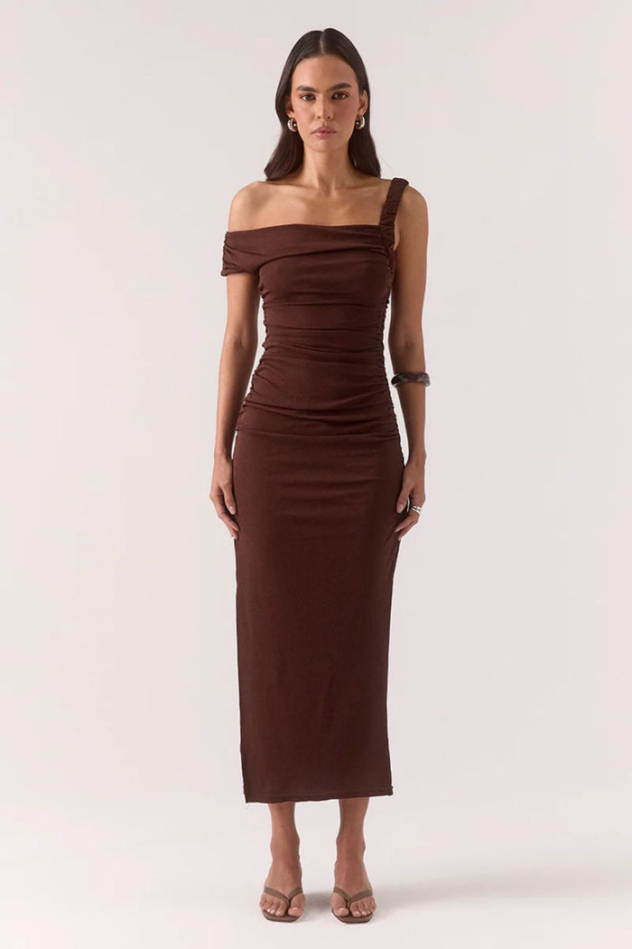 Woman wearing a brown off-shoulder dress on a white background