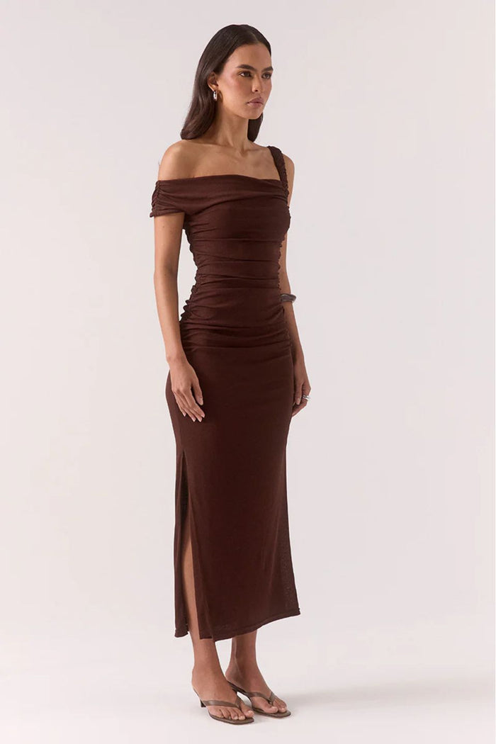Woman wearing a brown off-shoulder dress on a white background