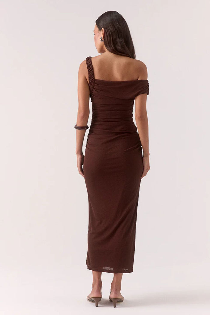 Woman wearing a brown one-shoulder dress on a white background