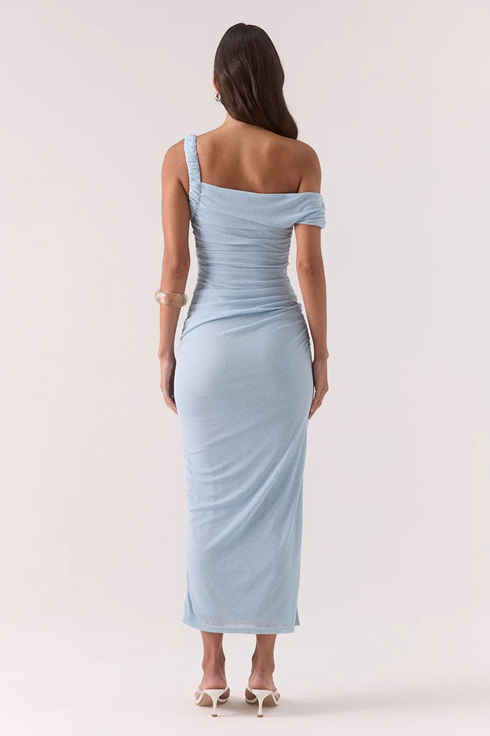 Woman wearing a light blue one-shoulder dress on a white background