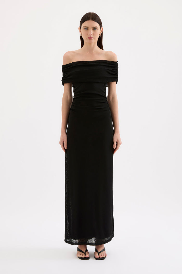 Woman wearing a black off-shoulder gown on a white background