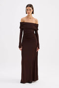 Woman wearing a brown off-shoulder gown on a white background