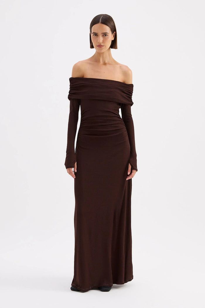 Woman wearing a brown off-shoulder gown on a white background