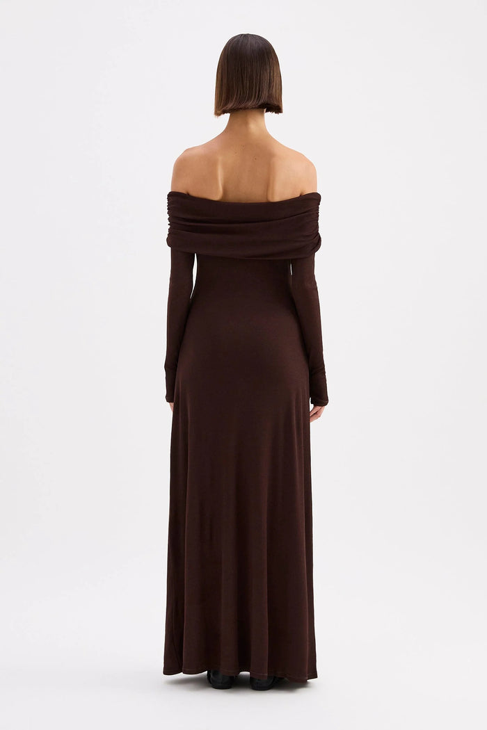 Woman wearing a brown off-shoulder dress on a white background