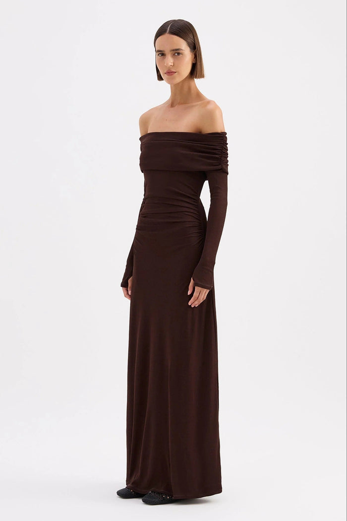 Woman wearing a brown off-shoulder gown on a white background