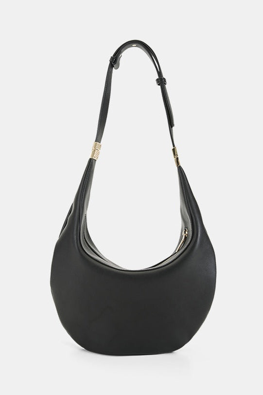 A black leather crescent-shaped shoulder bag with a single shoulder strap and gold-tone hardware, shown against a light gray background.