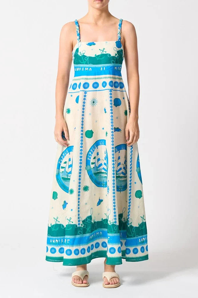 Woman wears a colourful blue strappy maxi dress