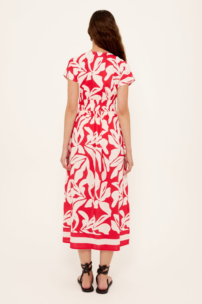 Woman wearing a red white floral dress