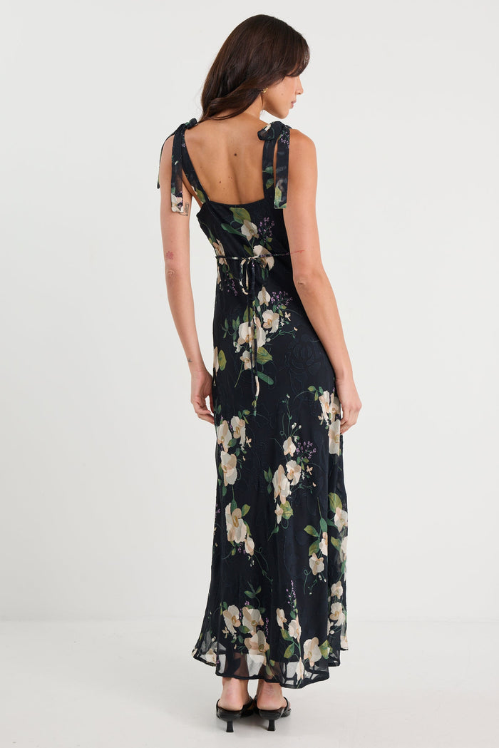 Woman wearing a black floral dress on a white background