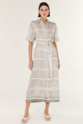 Woman wearing a patterned dress on a white background