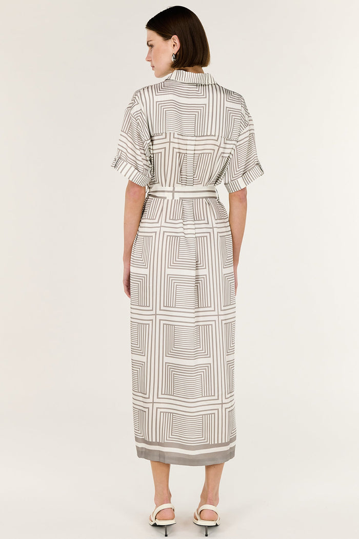 Woman wearing a patterned dress on a white background