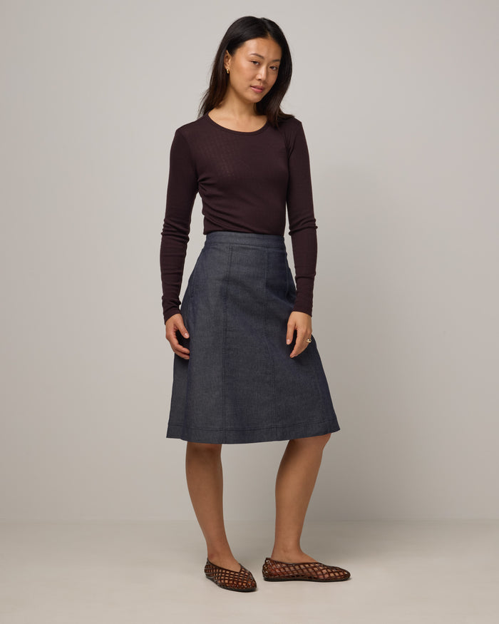 Model wearing Sloan Pointelle Fitted Tee in Espresso, a dark brown color. Sloan Pointelle Fitted Tee is a merino wool long sleeve, crew neck, slim fit tee available in sizes XS-3X.
