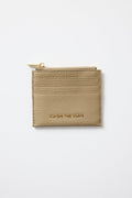Beige cardholder with gold zipper on a light gray background