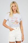 Woman wearing a graphic t-shirt with text and graphics on a plain background