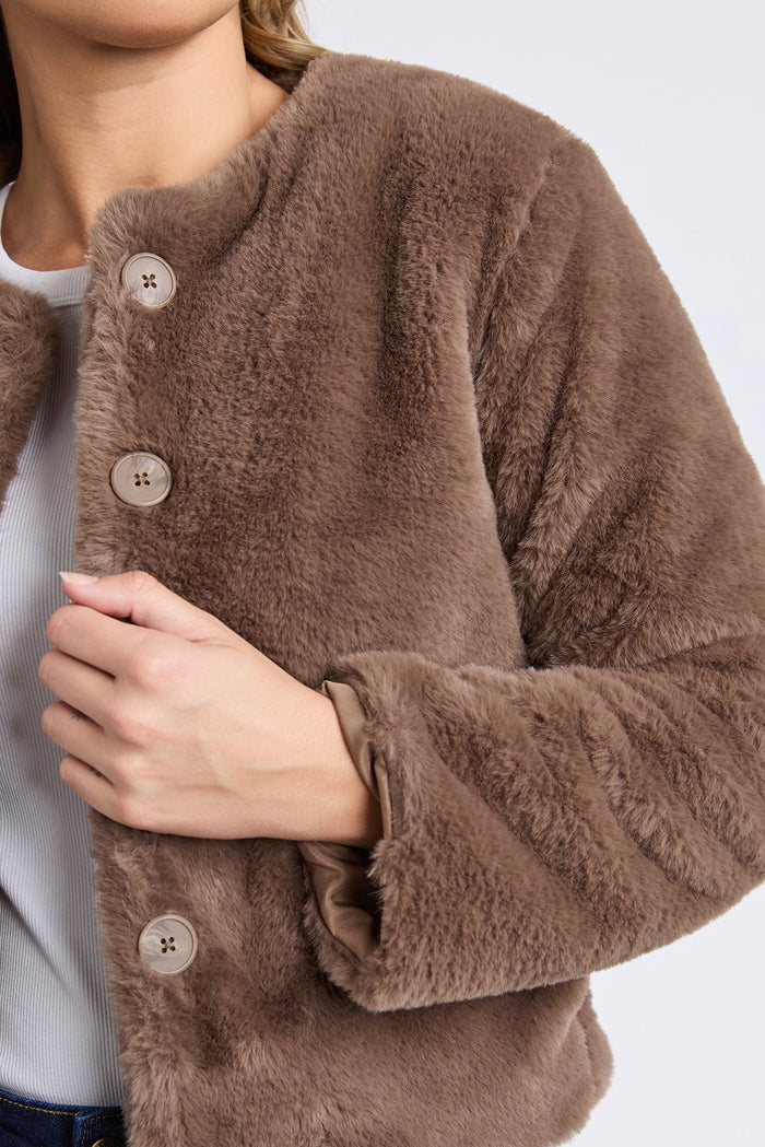 Brown fuzzy jacket with button details on a white background