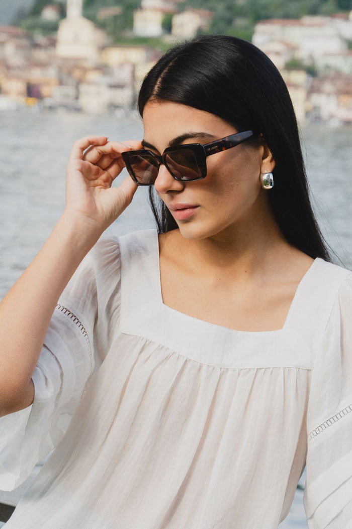 model wearing tort square sunglasses