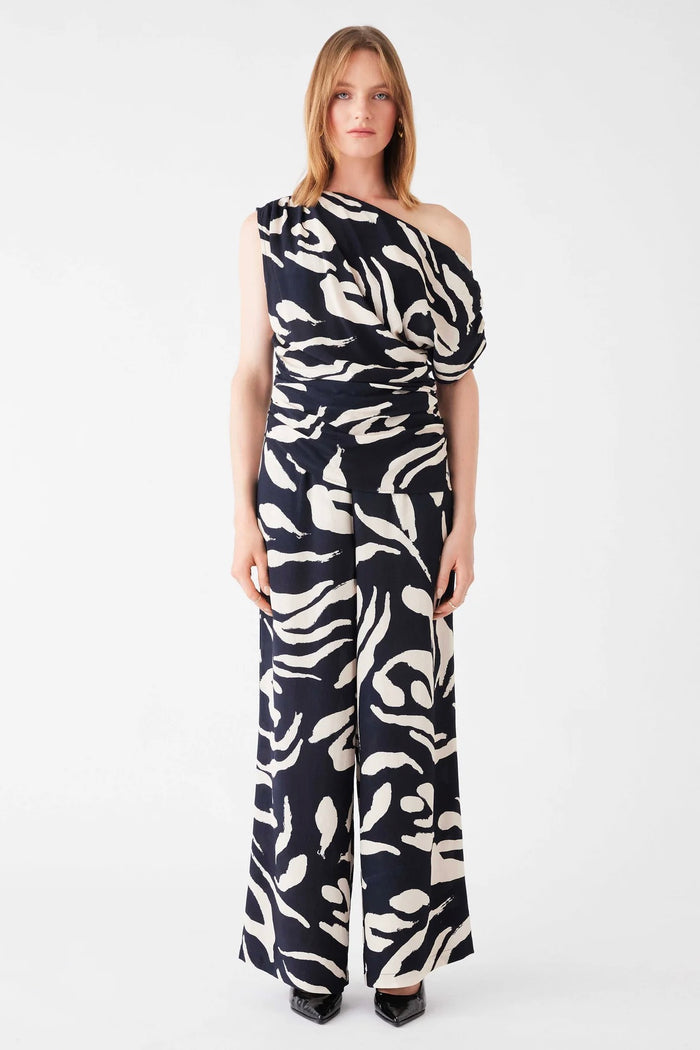 Model wears a one shoulder black and white pattern top