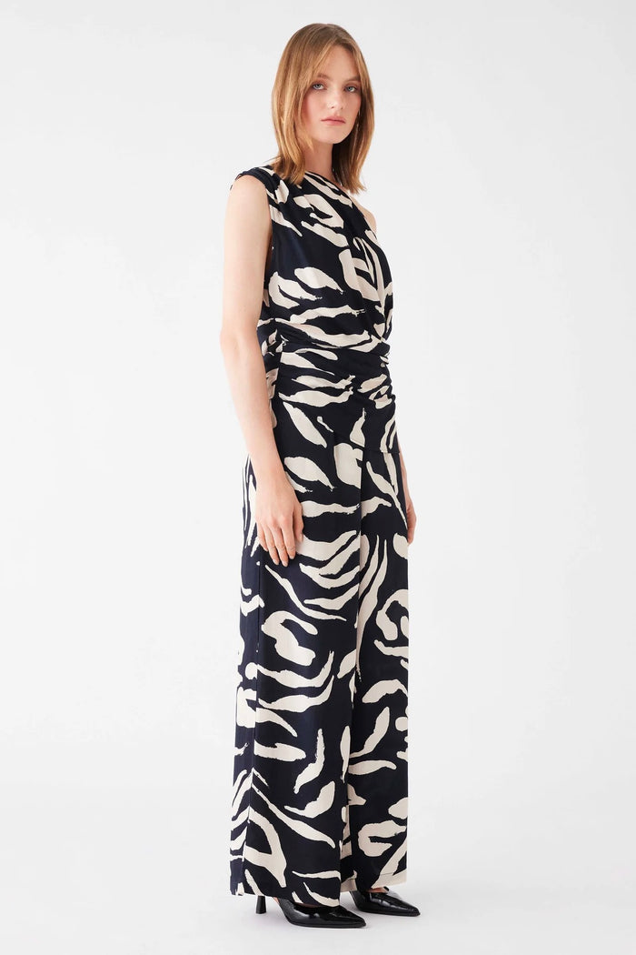 Model wears a one shoulder black and white pattern top