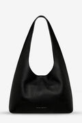 Black leather handbag on a light gray background